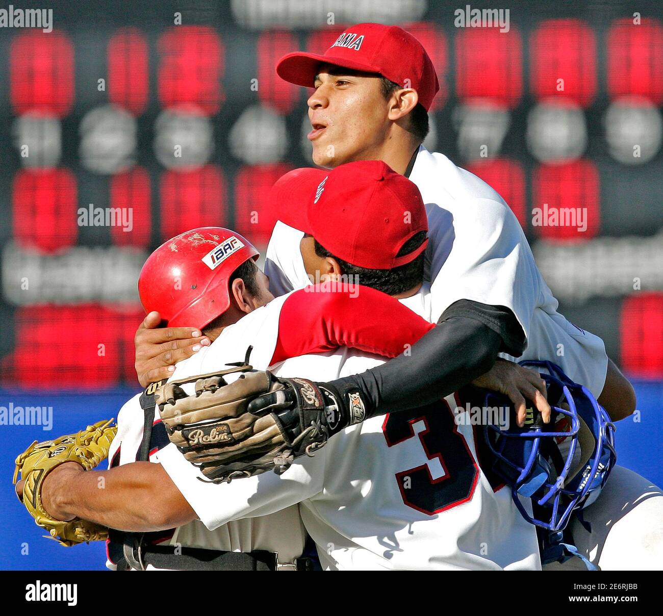 Panama's Lasso jumps on pitcher Gomez and catcher Munoz after their team  beat the Netherlands for the bronze medal at the World Cup Baseball in  Haarlem. Panama's Yoni Lasso (R) jumps on