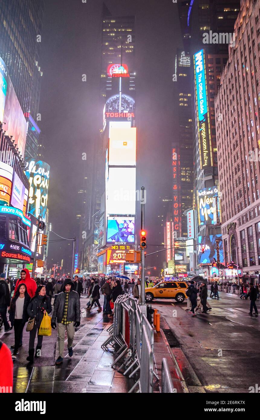 Crowded Times Square and Toshiba's New York Billboard at Night. Features Animated Bright Led Screens and Billboards. Manhattan, New York City, USA Stock Photo