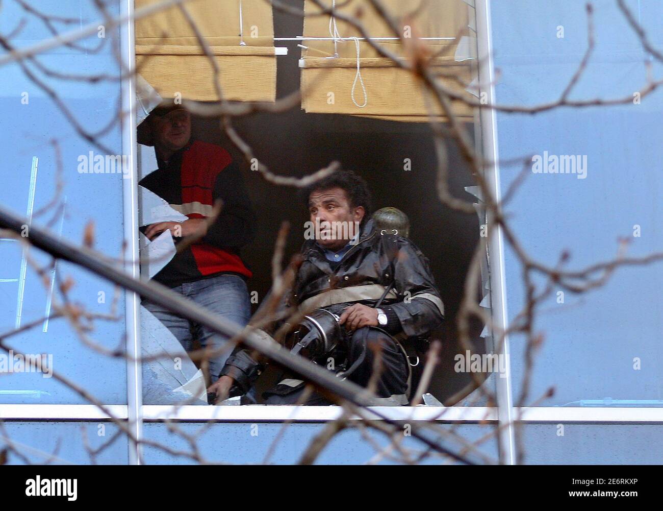 Albanian firefighters try to contain a fire at some shops from a nearby apartment building in Tirana December 26, 2006. There were no casualties but the shops suffered some material damage. REUTERS/Arben Celi (ALBANIA) Stock Photo