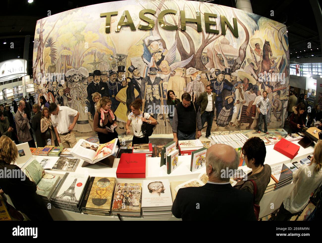 Visitors look at books of the German publishing house "Taschen" at the  Frankfurt book fair, October 10, 2007. The world's largest bookfair will be  open to public from October 10 to October
