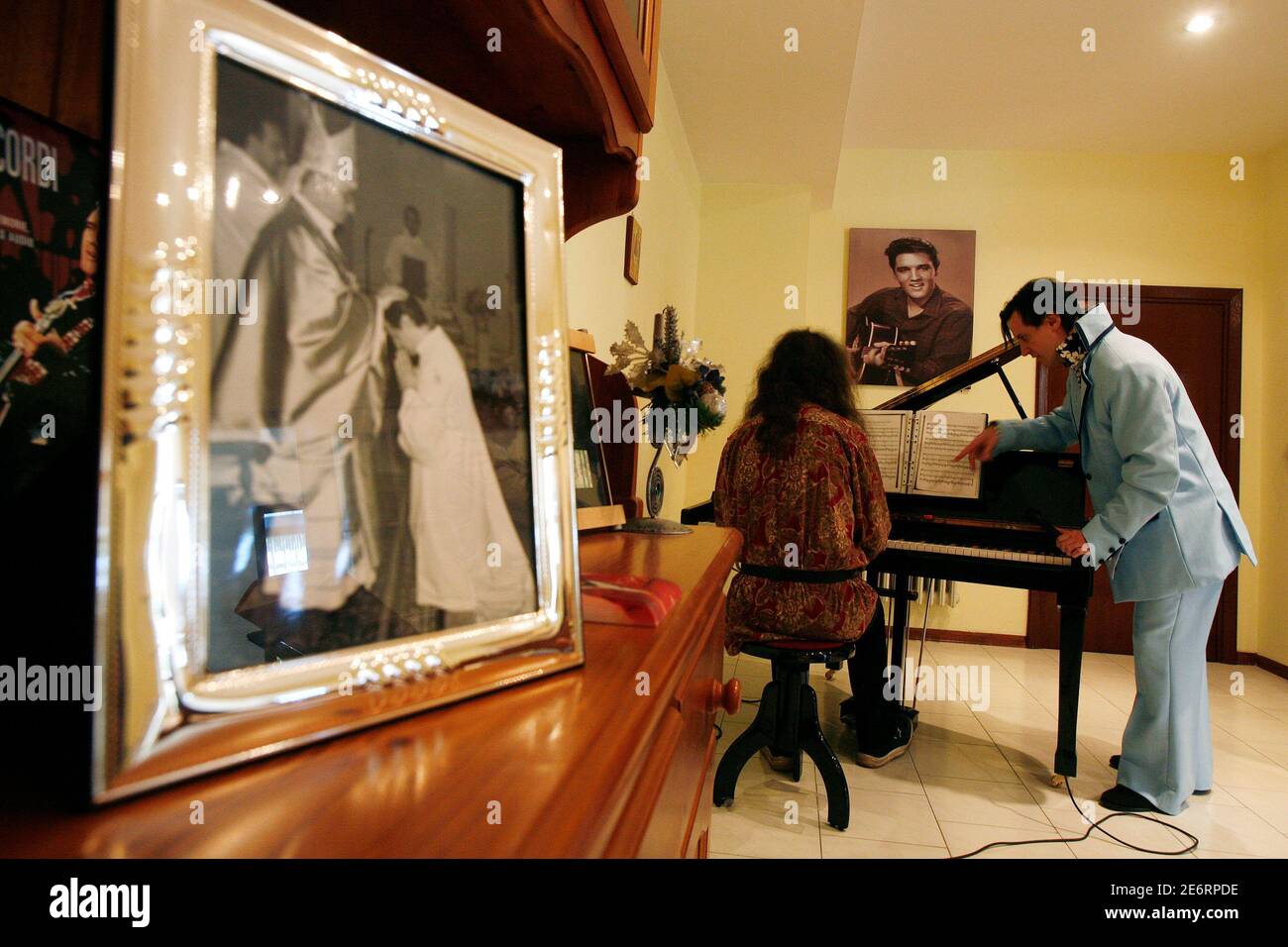 Father Antoniu Petrescu (R) and musician Fabrizio Fiale practice Elvis Presley songs at his home in the central Italian city of Avezzano October 14, 2007. Father Petrescu, a Romanian who became a Roman Catholic priest three years ago, is also an Elvis Presley impersonator. Picture taken October 14, 2007.   To match feature ITALY-ELVIS/      REUTERS/Dario Pignatelli   (ITALY) Stock Photo