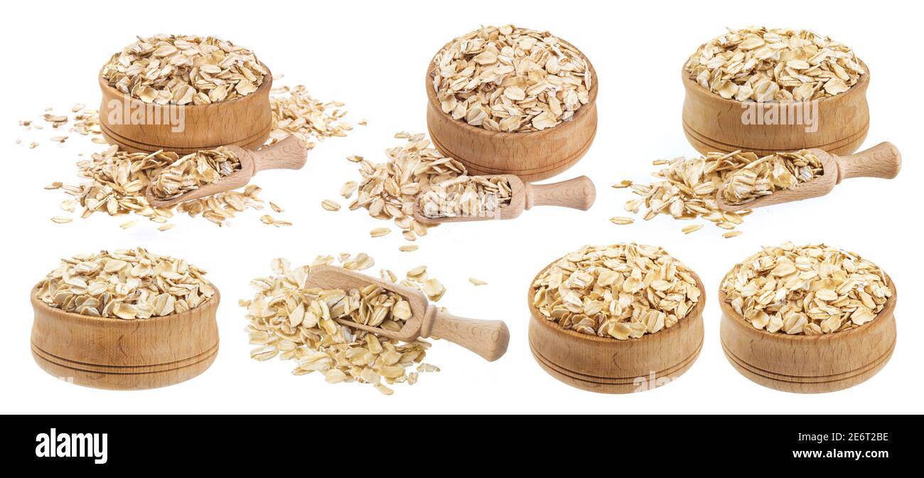 Isolated oat flakes. Wooden bowl and scoop with oatmeal Stock Photo