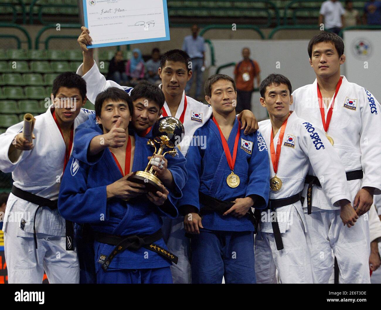 South Korean judo players celebrate as they receive their gold medals