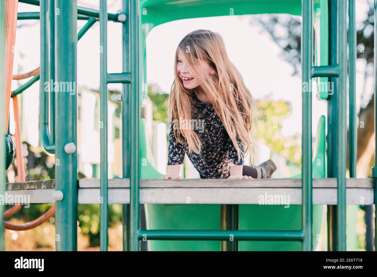 Young smiling girl playing at the playground Stock Photo - Alamy