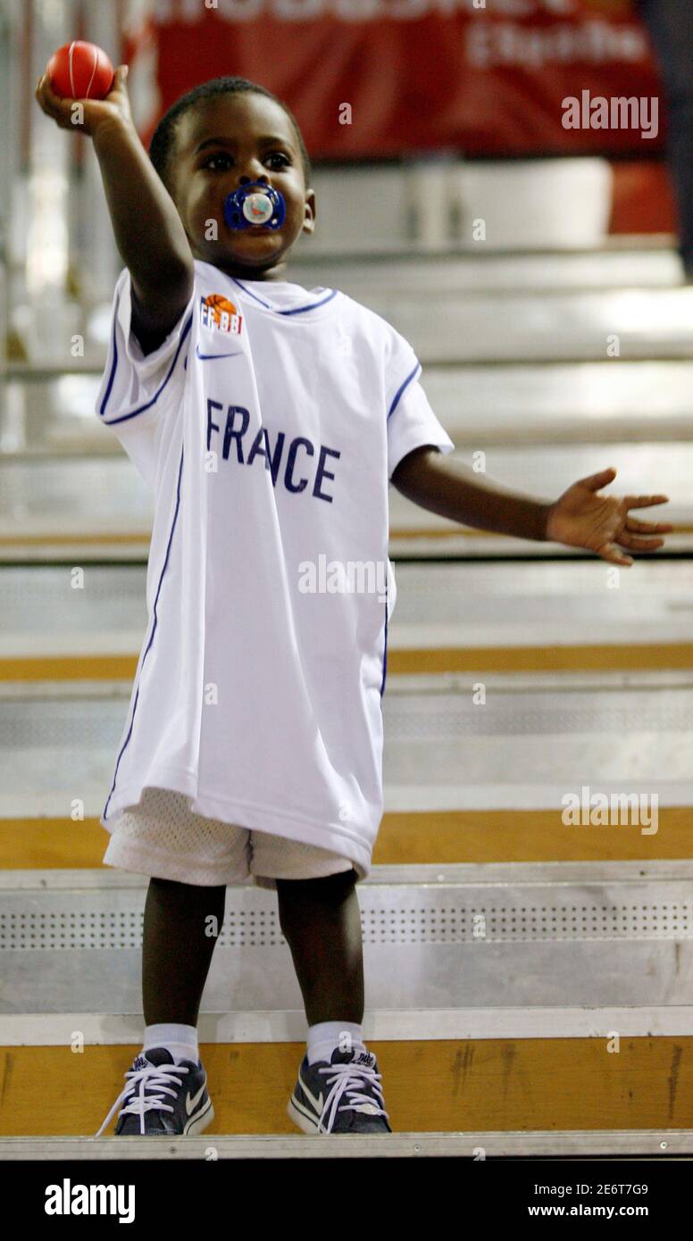 Illan Pietrus, son of France's Florent Pietrus, plays with a small  basketball after second round game between France and Lithuania at the  European Basketball Championships in Madrid September 10 , 2007.  REUTERS/Ivan