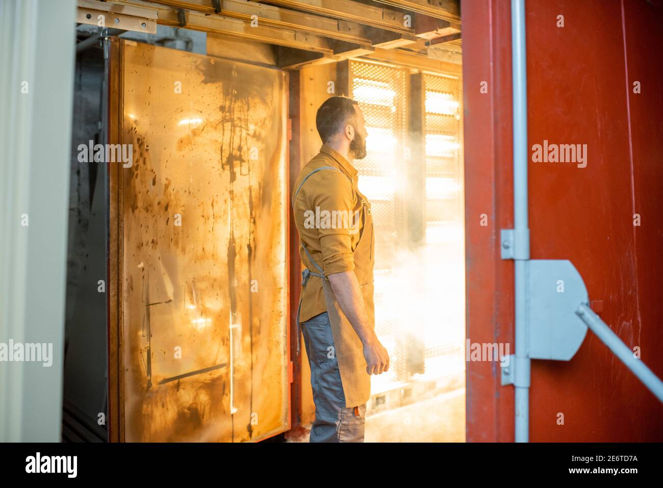 Worker checking the quality of the painted with powder coating metal products Stock Photo