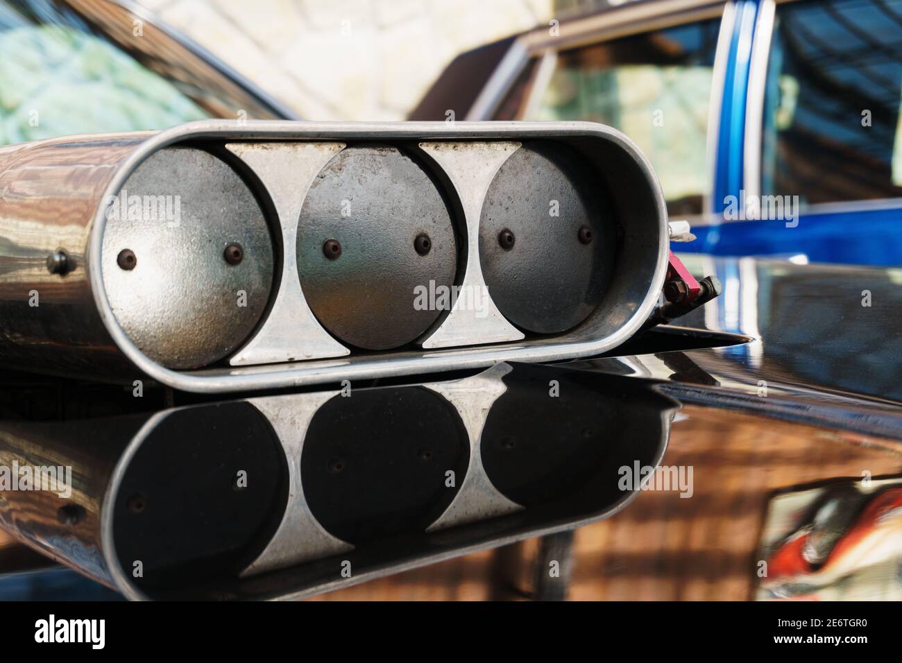 The throttle on the hood of the muscle car closeup. Hood scoop with