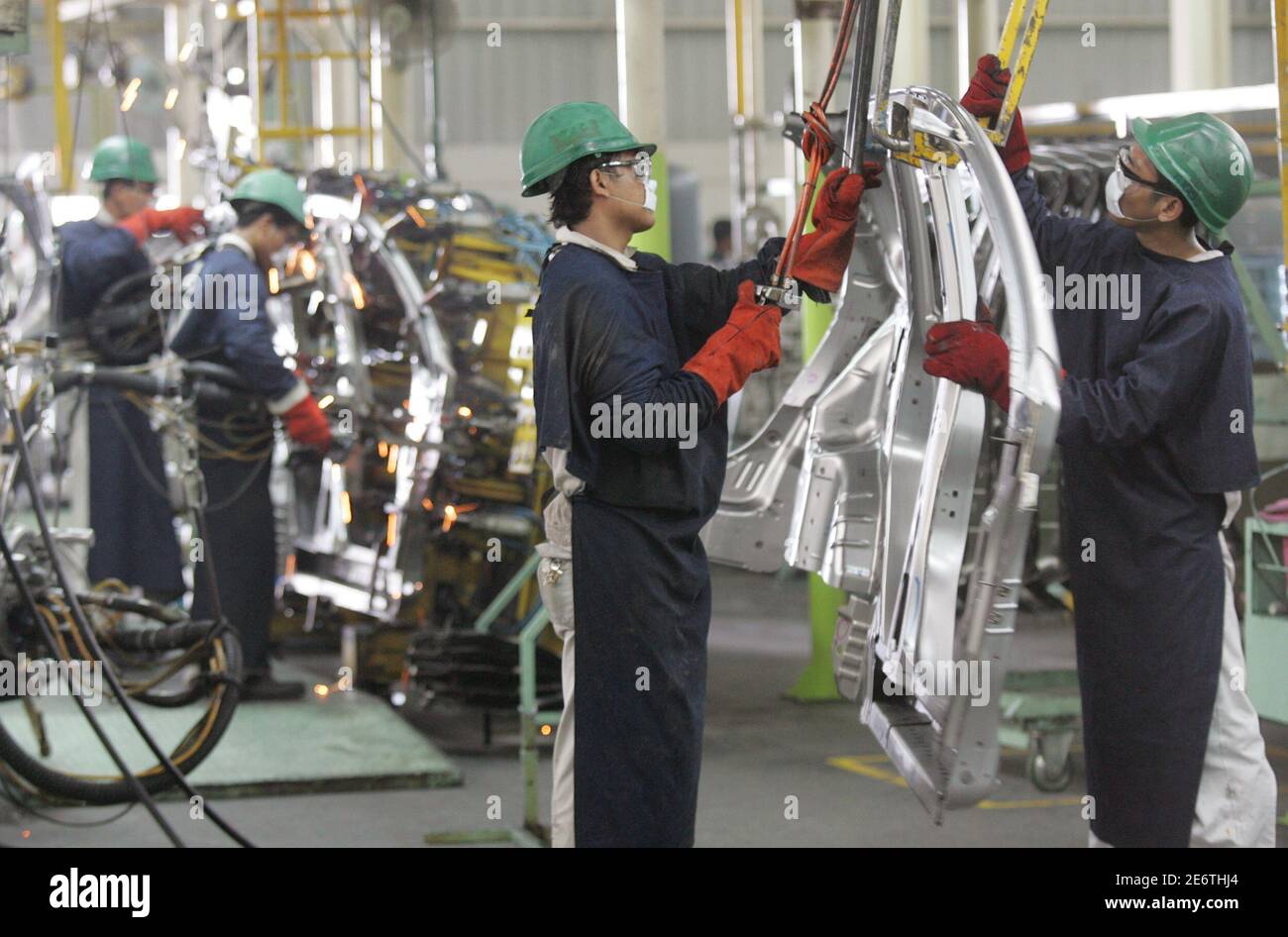 Indonesian workers assemble cars at 