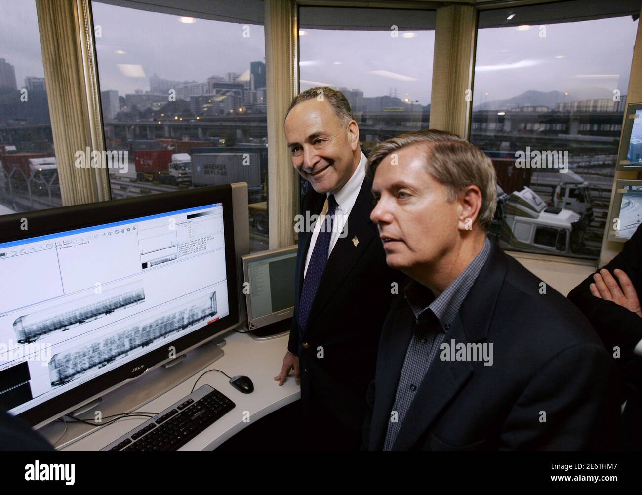 U.S. Senators Charles Schumer (L) of New York and Lindsey Graham of South Carolina visit a control room for monitoring the containers scanner at a Hutchison International container port in Hong Kong March 25, 2006. In the aftermath of the Dubai ports dispute, the Bush administration is negotiating with Hong Kong-based Hutchison Whampoa Ltd on a contract involving nuclear detection devices at Freeport, Bahamas, that would monitor cargo passing through to the United States.  REUTERS/Kin Cheung/Pool Stock Photo