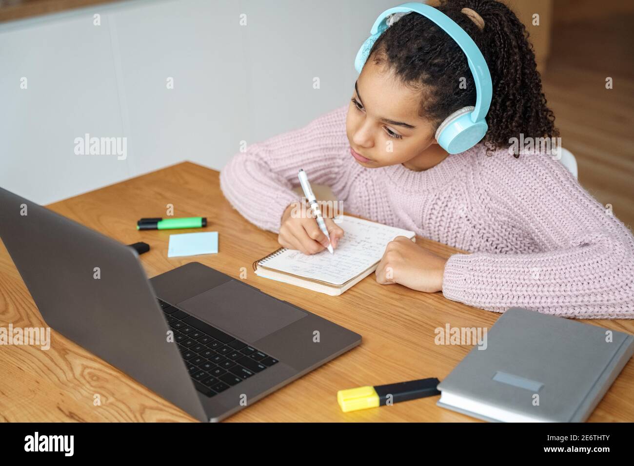 Portrait of teen student studying online on her laptop at home. Stock Photo