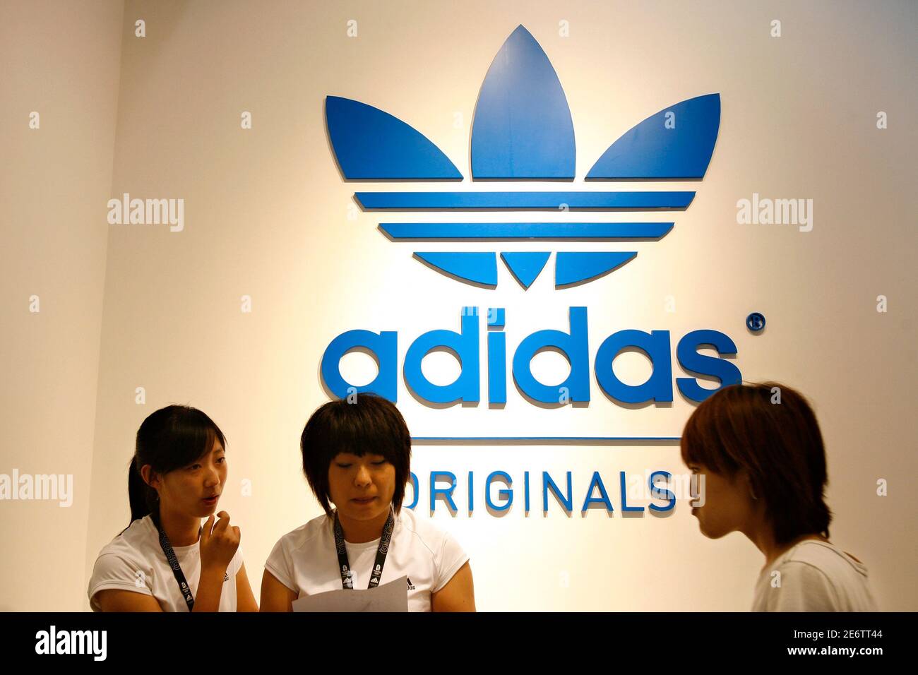 Staff chat inside the new and world's largest Adidas Brand Center store in  Beijing July 3, 2008. Adidas will open its world's largest Adidas store  with a size of 3,170 square metres