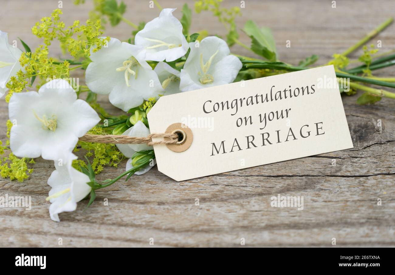 Greeting card with white bell flowers and english text  congratulations on your marriage Stock Photo