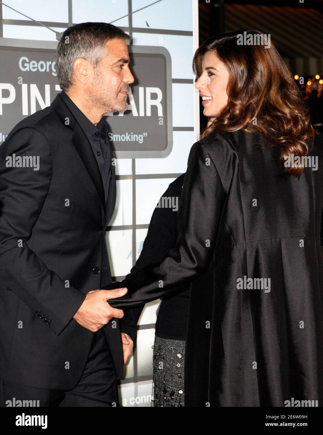 Actor George Clooney, star of the film 'Up In The Air', poses on the red carpet with girlfriend Elisabetta Canalis at the film's premiere in Los Angeles, California November 30, 2009. REUTERS/Fred Prouser    (UNITED STATES ENTERTAINMENT) Stock Photo
