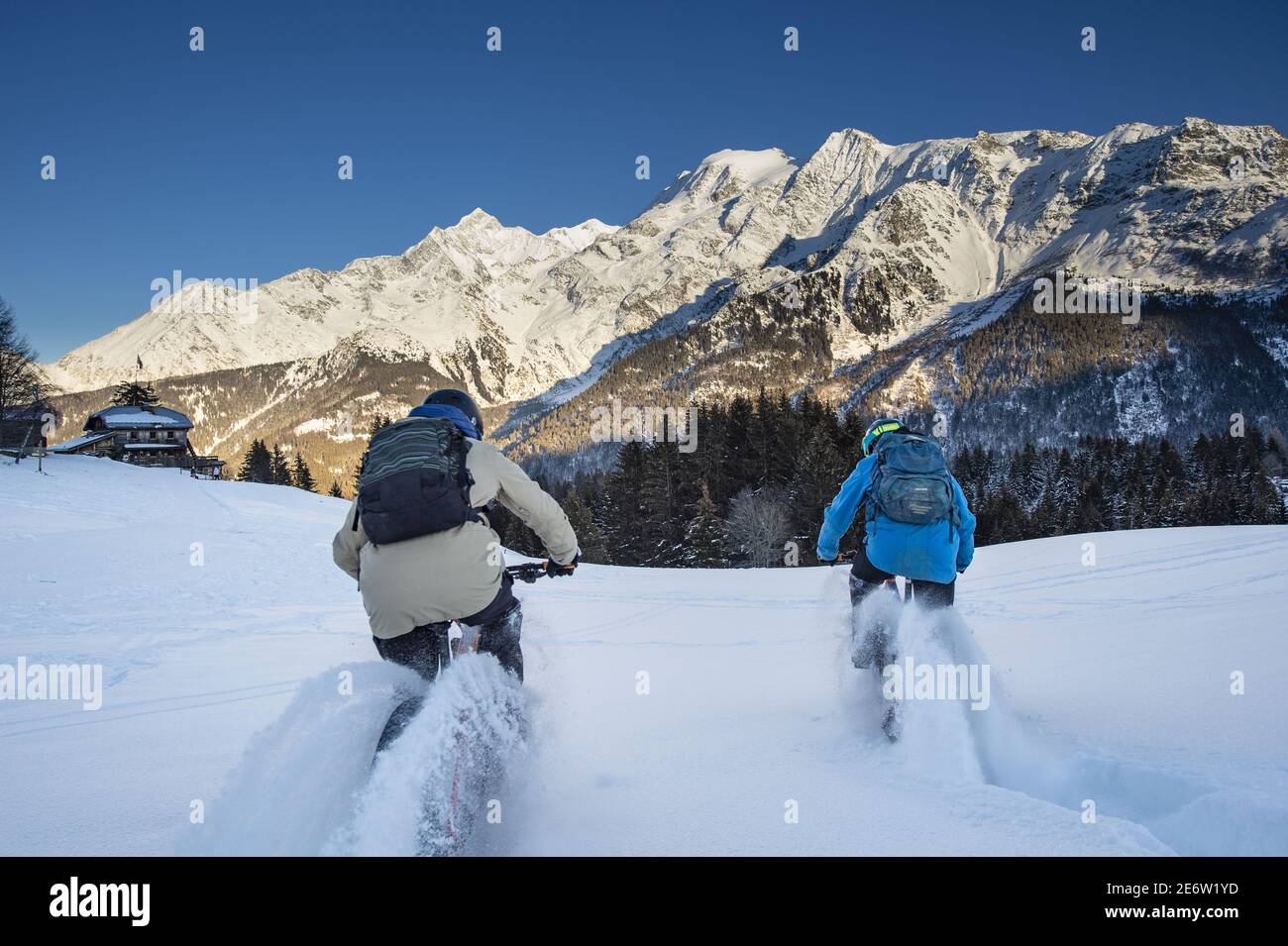 France, Haute Savoie, Mont Blanc massif, Les Contamines Montjoie, electric Fatbike on snow on the Colombaz chalets itinerary, very playful pedaling in the powder snow. Stock Photo
