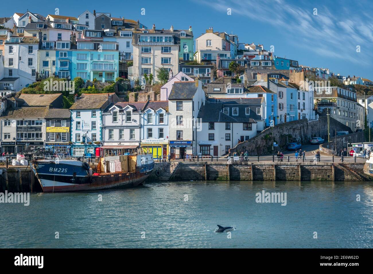 A trawler sits against the harbour wall as repairs are carried out at Brixham on the south coast of England. Stock Photo