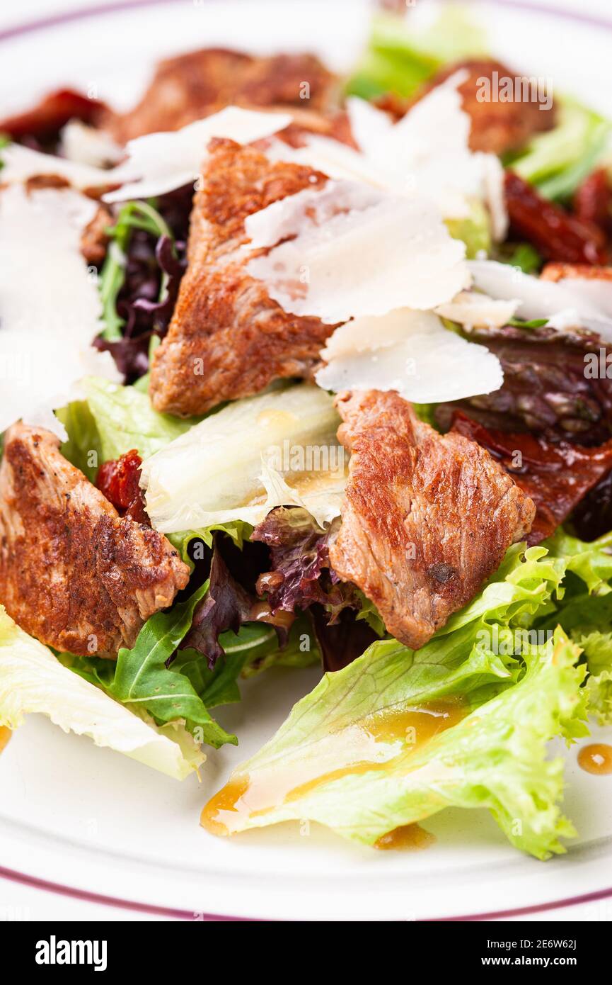 Closeup fresh salad with meat in white plate Stock Photo