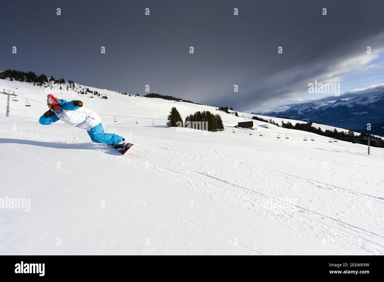 Switzerland, Canton of Valais, Morgins, snowboarder on the ski slopes. Stock Photo