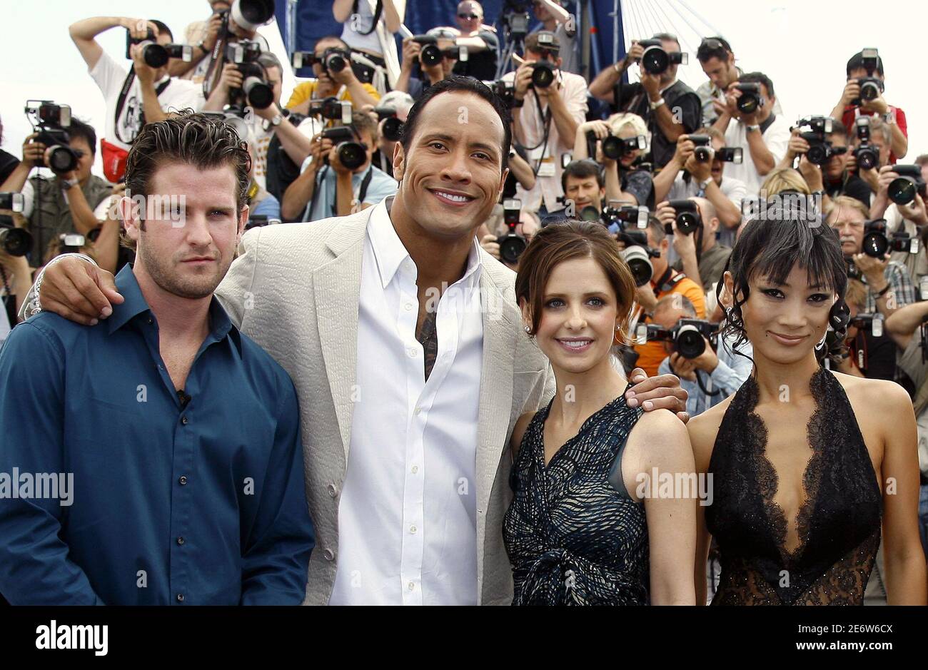 U.S. director Richard Kelly (L) and cast members Dwayne 'The Rock' Johnson, U.S. actress Sarah Michelle Gellar (2nd R) and actress Bai Ling (R) attend a photocall for the director's in-competition film 'Southland Tales' at the 59th Cannes Film Festival, May 21, 2006. Stock Photo