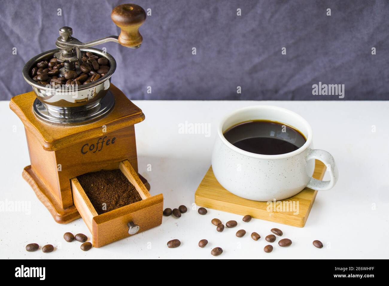 Coffee grinder and a cup of fresh coffee, morning coffee, energy drink