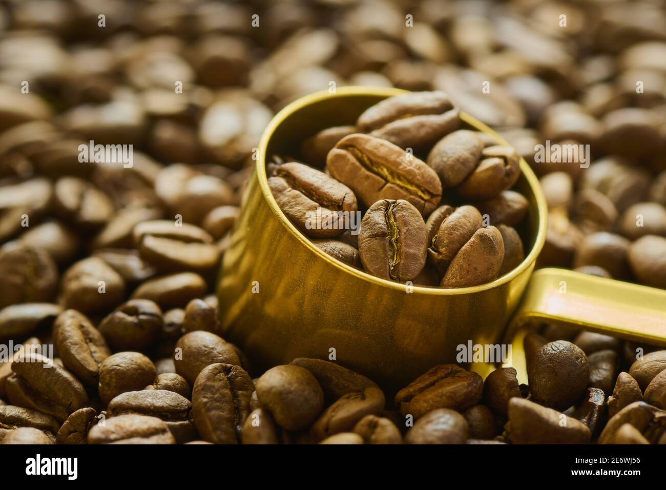 Coffee beans in a measuring spoon close up Stock Photo