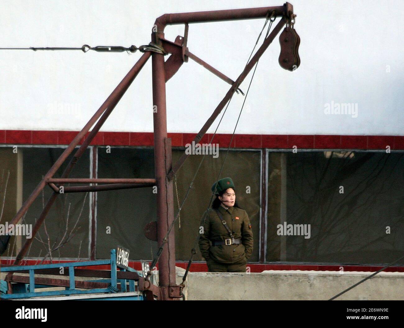 A North Korean soldier guards the banks of the Yalu River near the North Korean town of Sinuiju, opposite the Chinese border city of Dandong, March 25, 2010. North Korea's leader Kim Jong-il may soon visit China, bolstering ties between the two neighbours while regional powers and Washington seek to draw Pyongyang back to nuclear disarmament talks. Picture taken March 25, 2010. REUTERS/Jacky Chen (NORTH KOREA - Tags: POLITICS MILITARY) Stock Photo