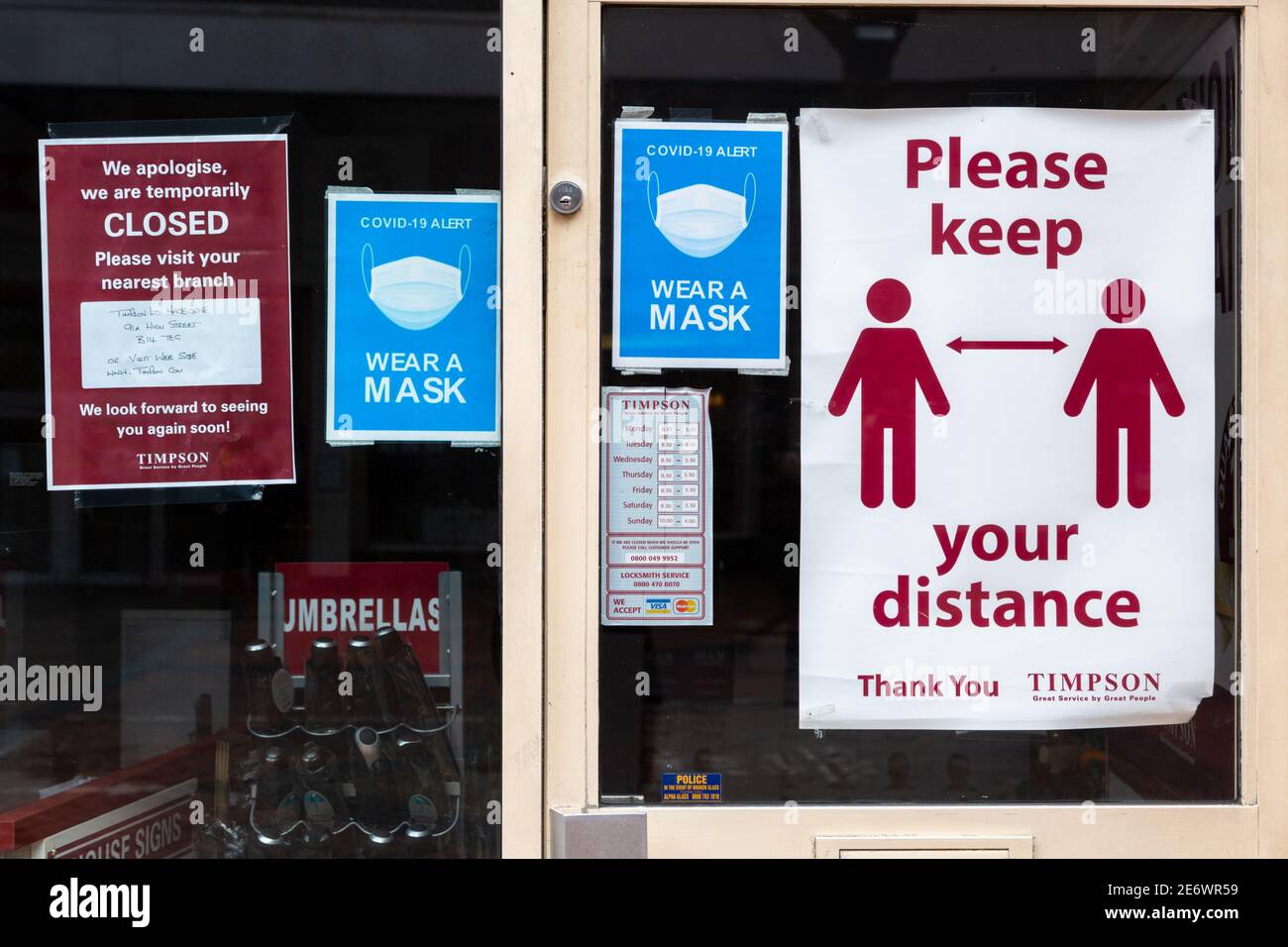 Timpson shop door with covid safety signs, UK 2021 Stock Photo
