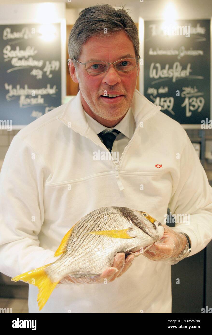 'Nordsee'-fast food chain owner Heiner Kamps poses for photographers with a fish after a news conference in Vienna February 23, 2006. Stock Photo