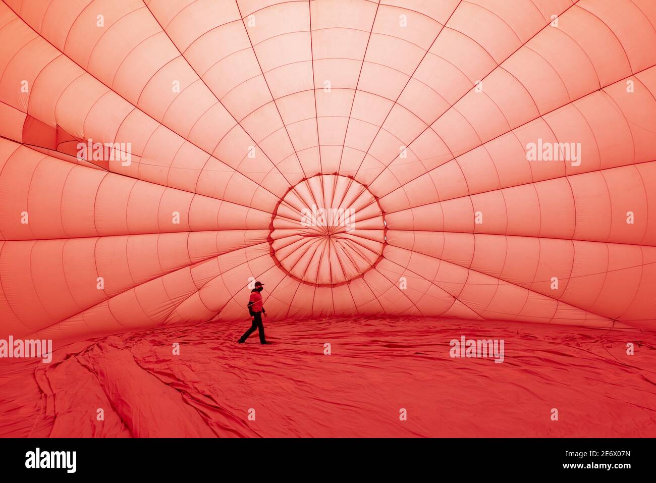 France, Indre et Loire, Loches, man walking inside a hot air balloon while being inflated Stock Photo