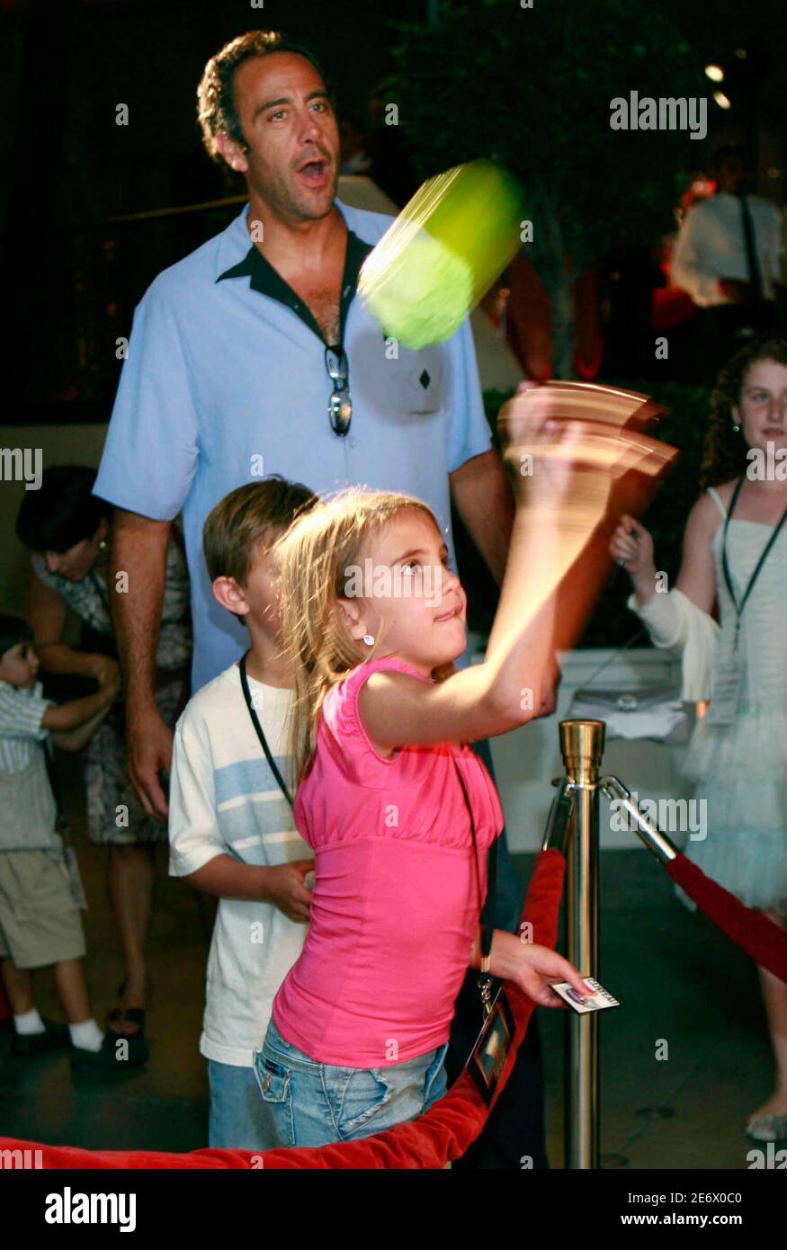 Actor Brad Garrett (top) watches his daughter Hope play games at the after  party for the premiere of the Pixar animated film 