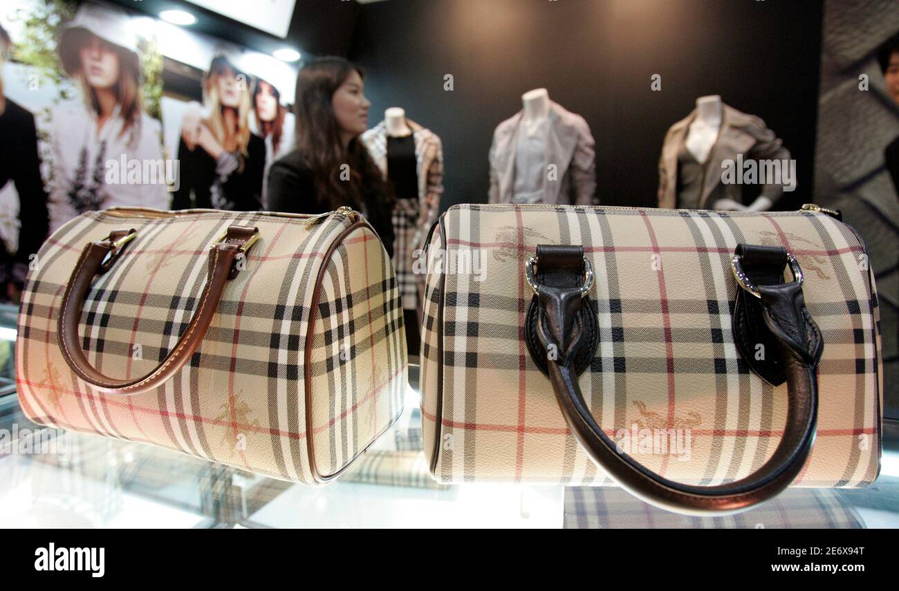 A real Burberry bag (R) and its counterfeit copy are displayed during the  Counterfeit Comparison Exhibition 2009 organised by the Korea Customs  Service (KCS) at a convention centre in Seoul May 27,