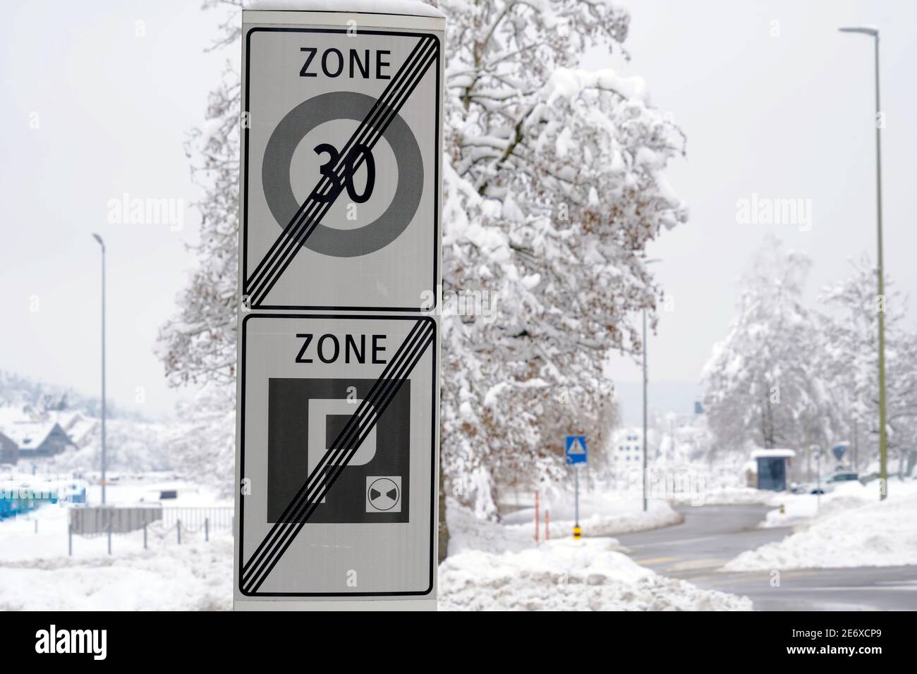 Traffic signs marking end of residential district, end of reduced speed zone of 30 km and end of parking zone in village Urdorf in Switzerland. Stock Photo