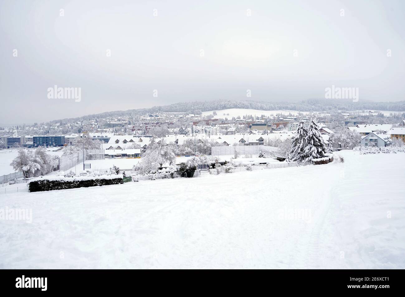 Panoramic view of village Urdorf in Switzerland in winter. It is covered with snow in extreme snowfall in January 2021. Stock Photo