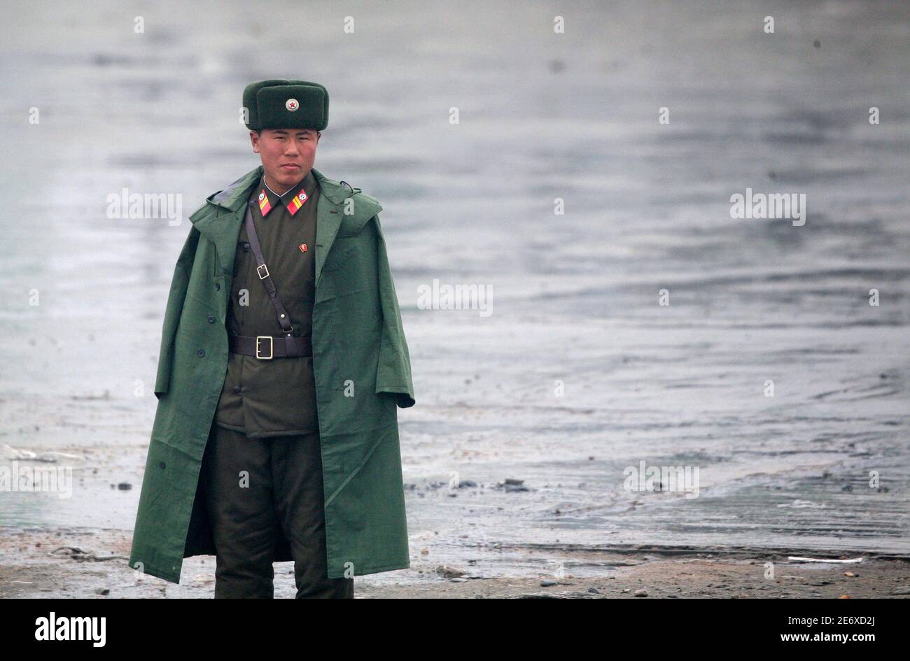 A North Korean soldier guards the banks of the Yalu River near the North Korean town of Sinuiju, opposite the Chinese border city of Dandong, March 31, 2010. North Korea warned on Monday of unpredictable disaster unless the South and the United States stop allowing tourists inside a heavily armed border buffer that is one of the most visited spots on the peninsula. The warning comes afters tensions rose when a South Korean navy ship sank on Friday. Early reports that the North may have been involved spooked markets but Seoul later said it was almost certain Pyongyang had played no part.  REUTE Stock Photo