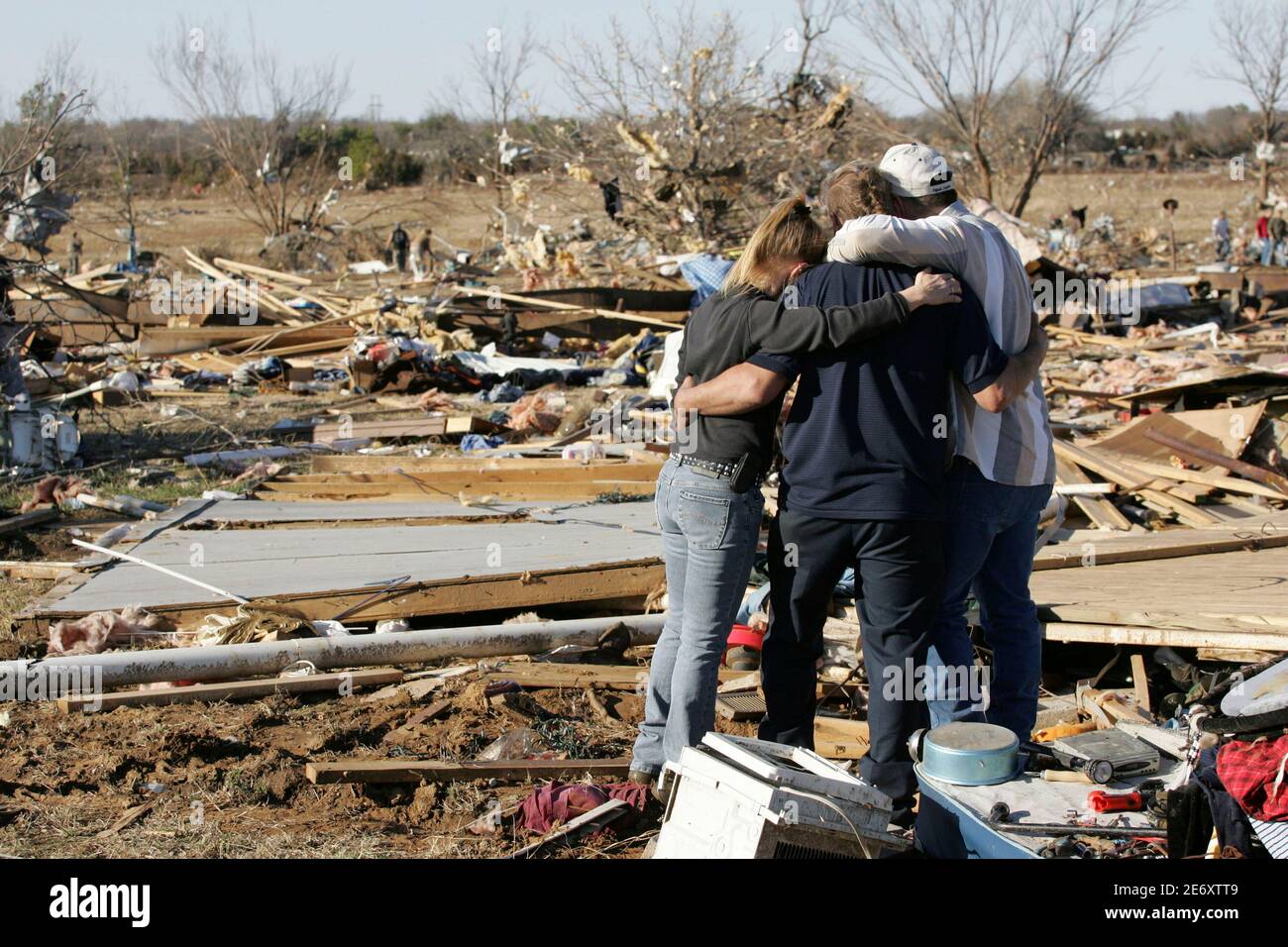 Barbie Vaughn, Dennis Parker, and Bobby Parker embrace as they view the ...