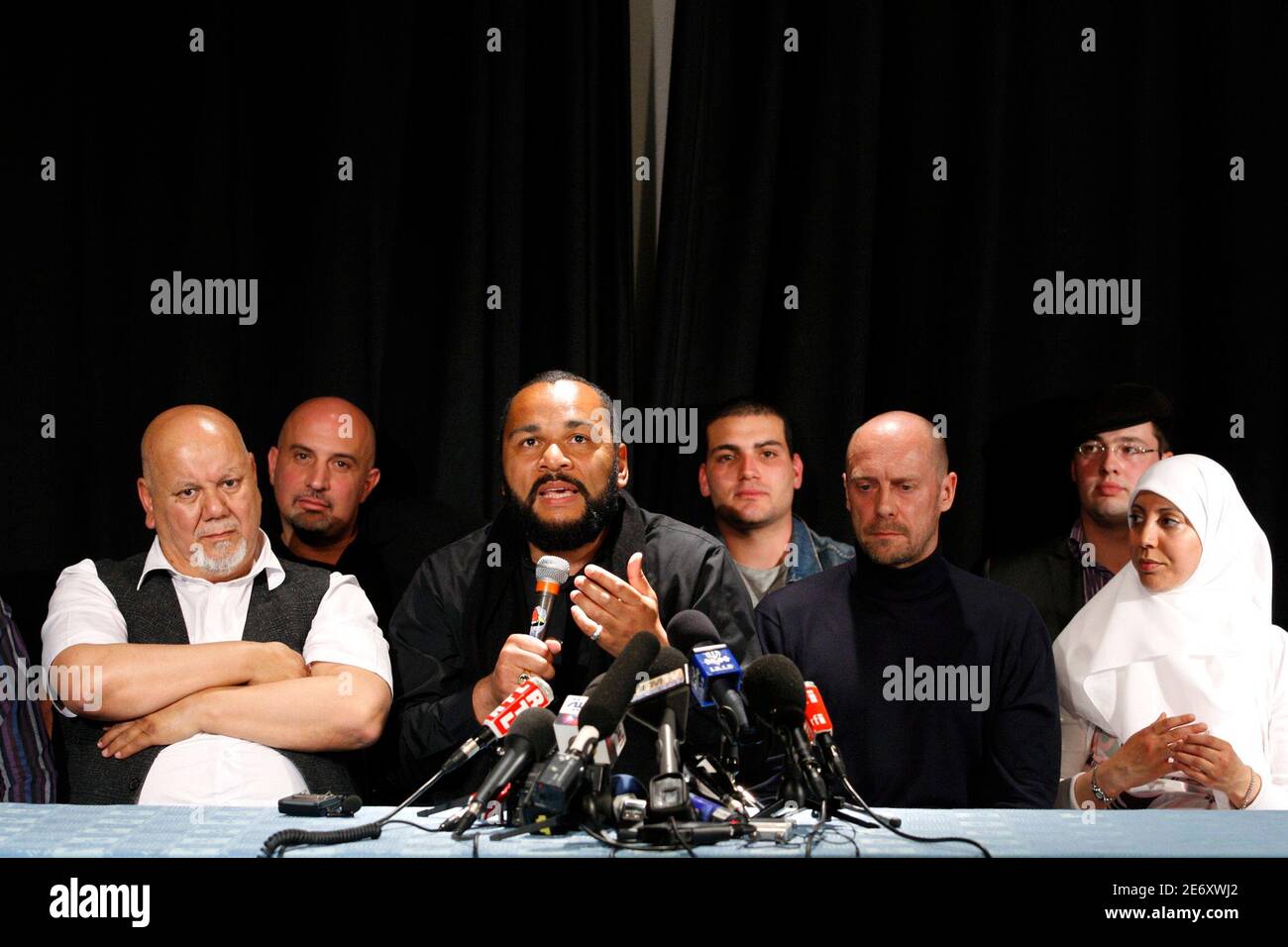 French humorist Dieudonne M'bala M'bala, also known as Dieudonne (C), along  with French writer and former France's far-right National Front political  party adviser Alain Soral (3rd R) attend a news conference in