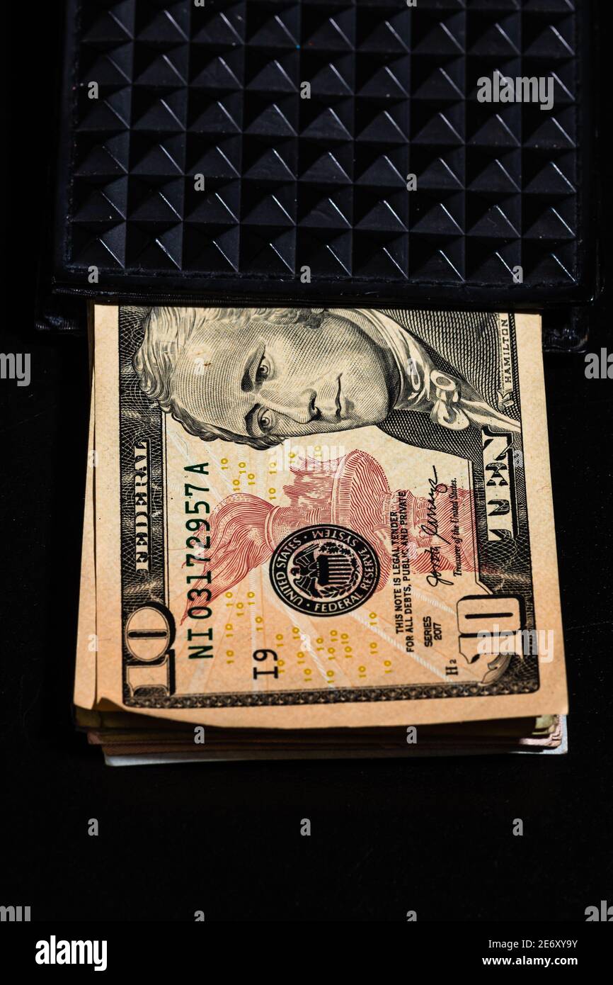 10 Dollars banknotes in a black wallet isolated Stock Photo - Alamy