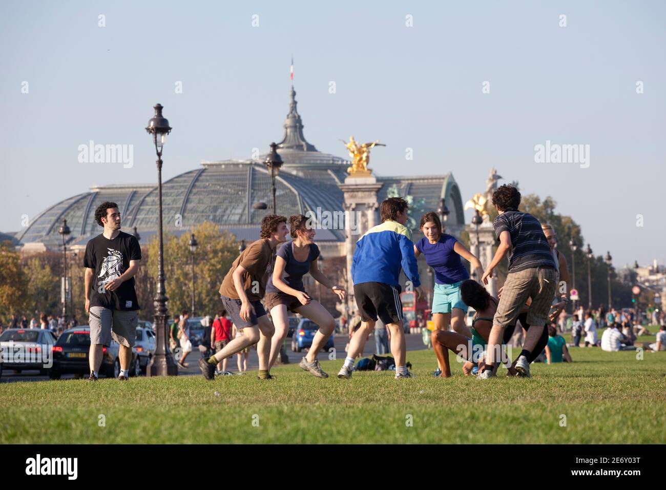 Young people on a lawn with the Grand Palais in the background. Stock Photo