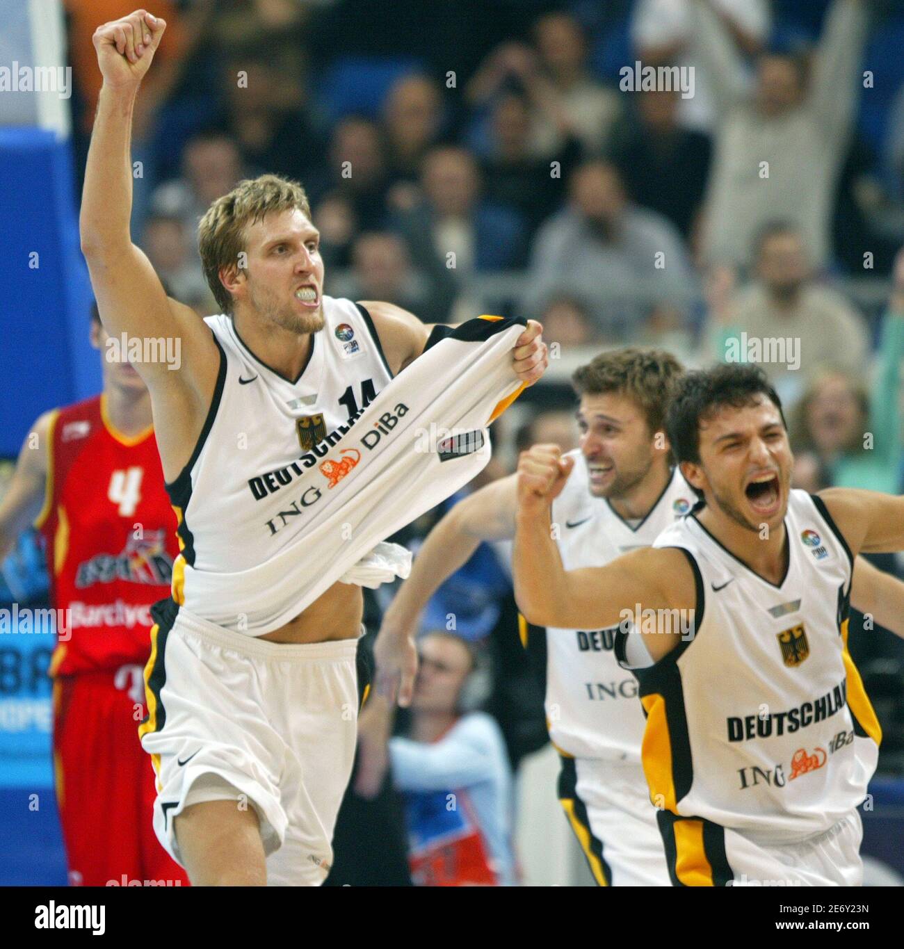 Germany's players (L-R) Dirk Nowitzki, Marco Pesic and Mithat Demirel  celebrate after beating Spain at the European basketball championship semi- final match in Belgrade, Serbia & Montenegro September 24, 2005. Germany  won 74-73