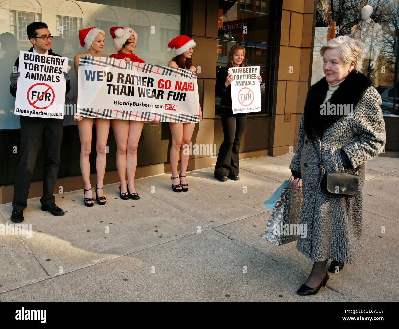 A passer-by looks at demonstrators from People for the Ethical Treatment of  Animals (PETA) protesting against the use of animal furs in Burberry  products, outside the Burberry store on Newbury Street in