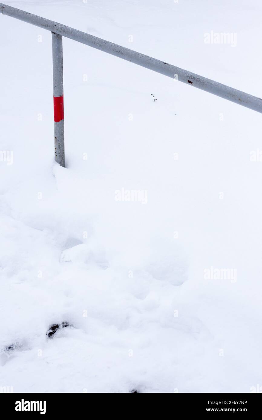 Steel railing on a white snow background Stock Photo - Alamy