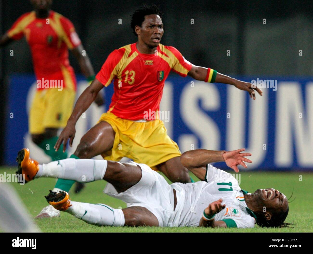 Ivory Coast's Didier Drogba falls after a challenge by Guinea's Mohamed Sacko during their African Nations Cup quarter-final soccer match in Sekondi February 3, 2008. REUTERS/Siphiwe Sibeko (GHANA) Stock Photo