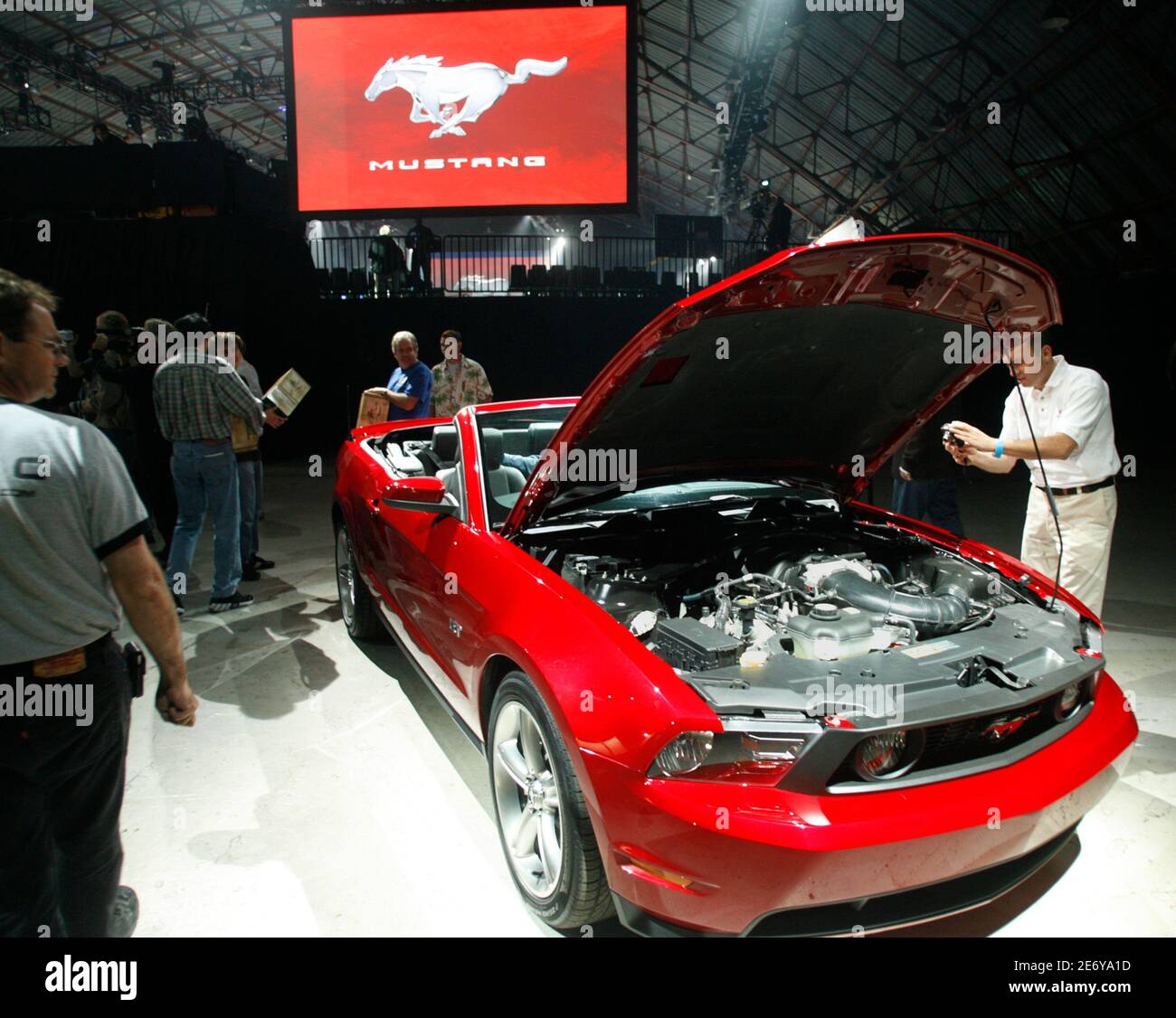 A car enthusiast takes a picture of Ford's 2010 Mustang at an unveiling in Santa Monica, California November 18, 2008. Ford Motor Co. unveiled a new version of its iconic Mustang sports car on Tuesday with an exterior that differs in every way from its predecessor, except for the roof panel.  REUTERS/Fred Prouser      (UNITED STATES) Stock Photo
