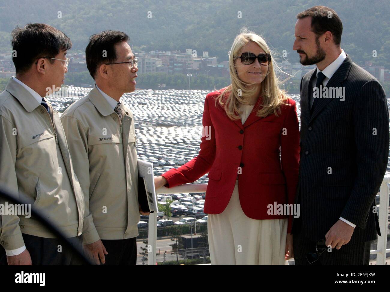 Norwegian Crown Prince Haakon (R) and Crown Princess Mette-Marit (2nd R) visit one of the ships owned by Wilh. Wilhelmsen's Korean joint venture EUKOR, which handles all car exports from South Korea for Hyundai Motor Company and Kia Motors corporation, at Hyundai Motor's export port in Ulsan, about 410 km (256 miles) southeast of Seoul, May 11, 2007.  REUTERS/Jo Yong-Hak (SOUTH KOREA) Stock Photo