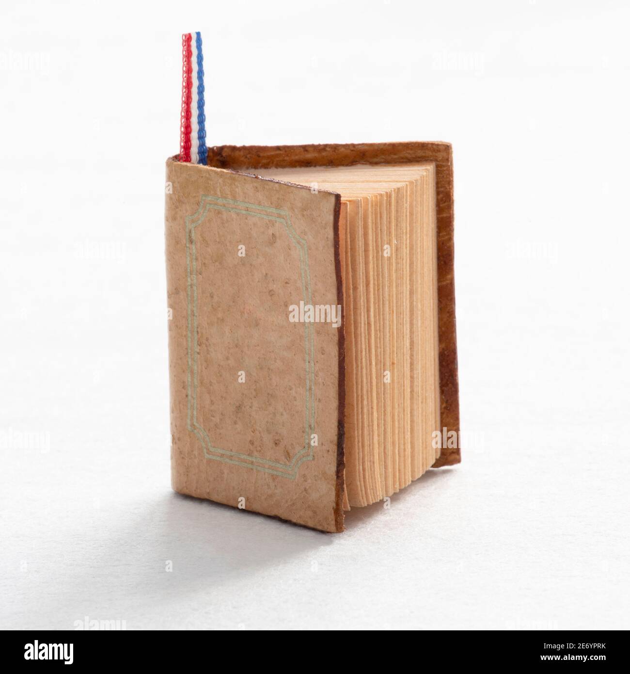 A book on the edge on a white background Stock Photo