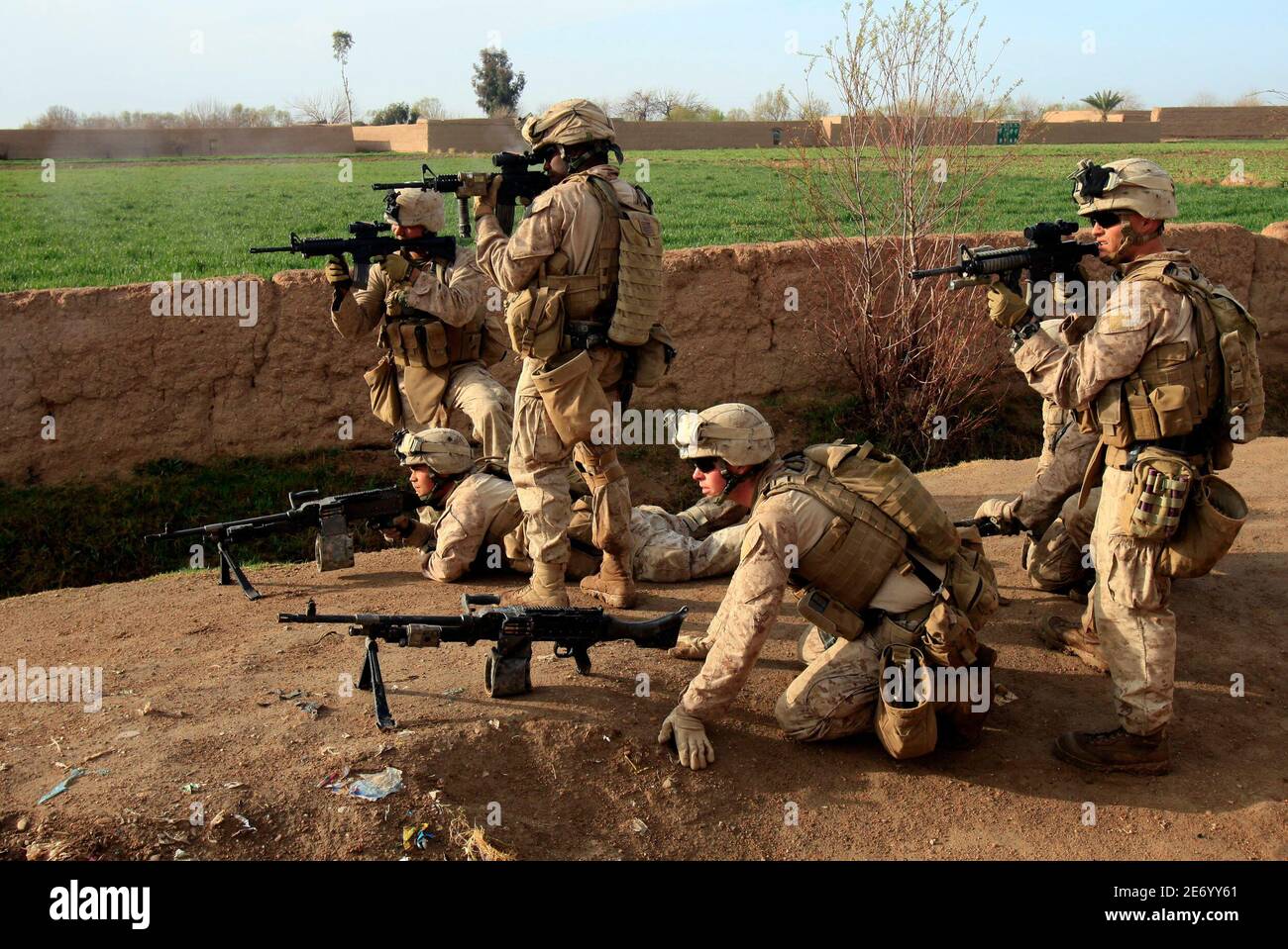 U.S. Marines from Bravo Company of the 1st Battalion, 6th Marines fire their weapons at Taliban fighters in Marjah, Helmand province February 22, 2010.   REUTERS/Goran Tomasevic  (AFGHANISTAN Tags: - Tags: MILITARY CONFLICT) Stock Photo