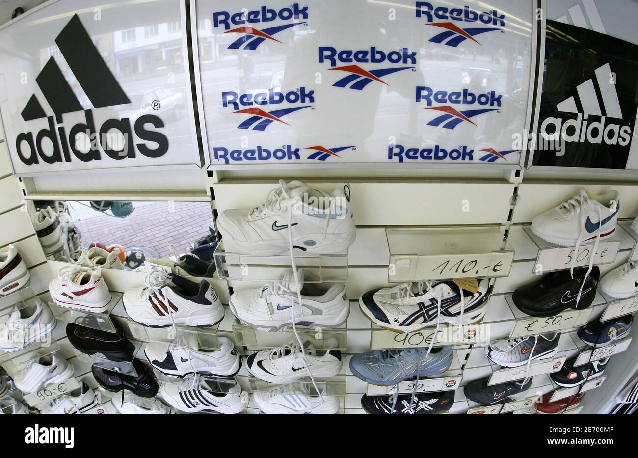 Sport shoes are displayed in store in the northern German town of Hamburg August 3, 2005. German sporting maker Adidas-Salomon is buying U.S. rival a 3.1 billion euros ($