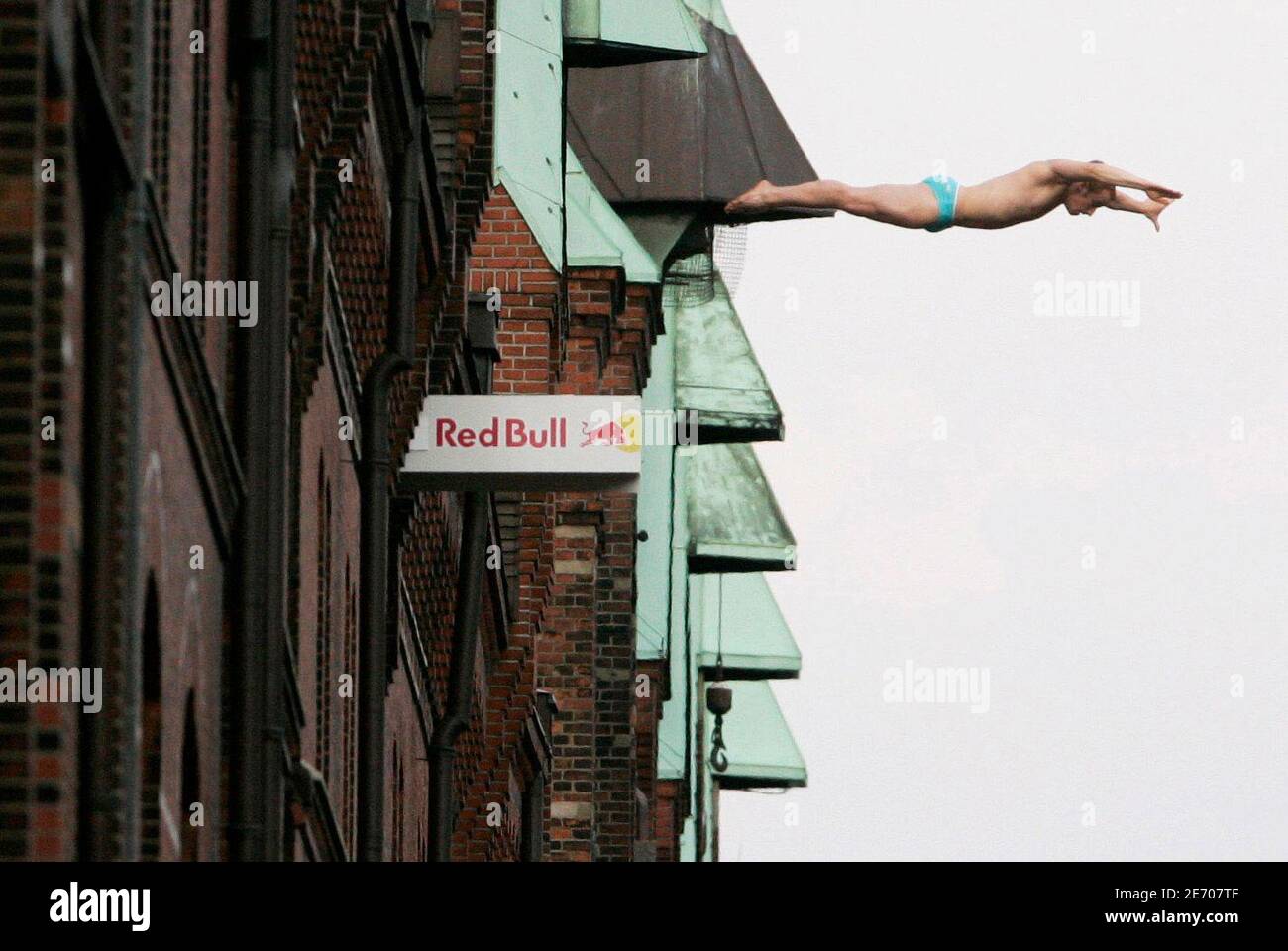 Cliff diver Alain Kohl from Luxemburg plunges towards a canal 22 metres  below him at the historic warehousing quarter Speicherstadt at the harbour  of the northern German city of Hamburg August 19,