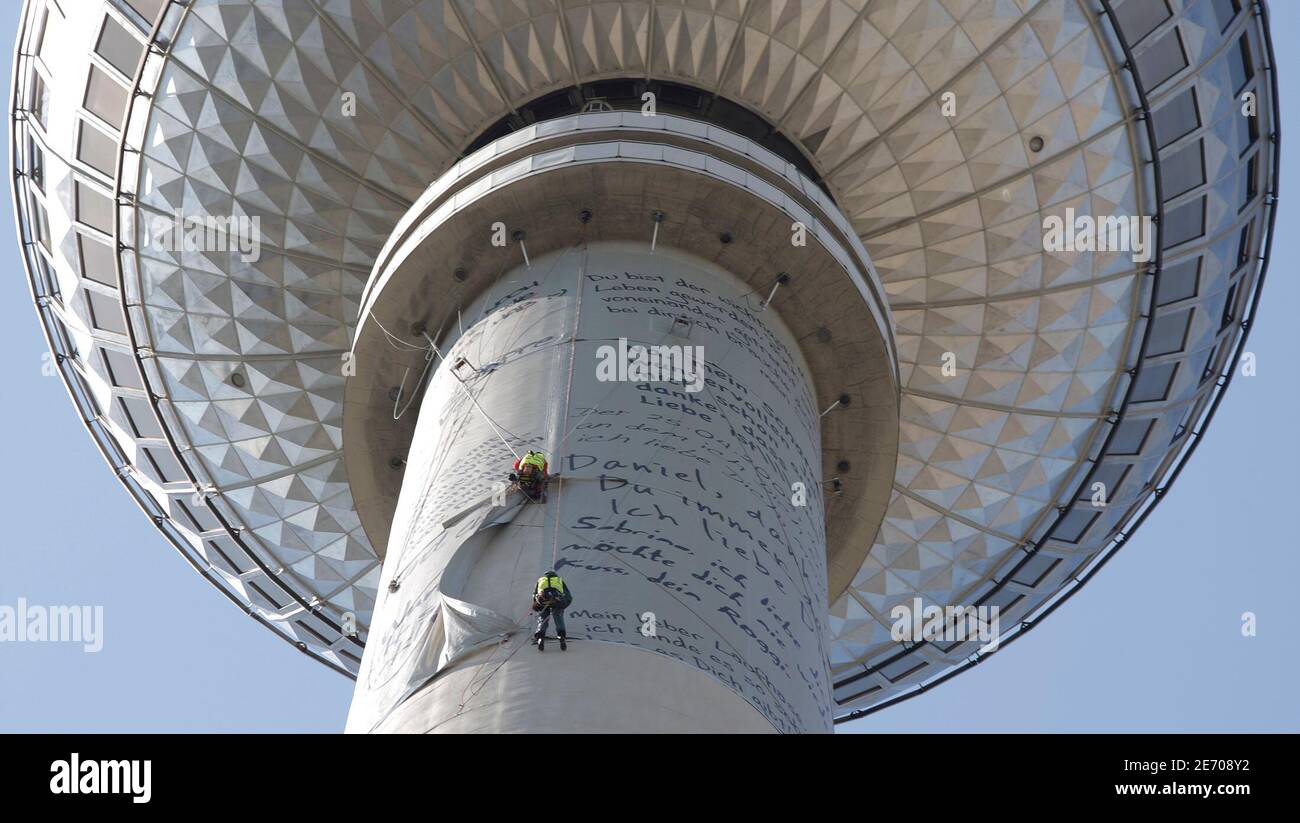 Workers attach banners of printed love letters at the television tower in  Berlin, April 19, 2009. Some 70 letters and one marriage proposal, which  were picked from a nationwide competition on the