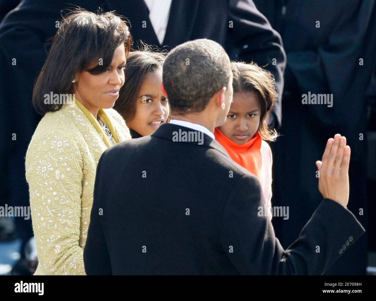 Barack Obama is accompanied by his wife Michelle and daughters Malia and Sasha while he takes the Oath of Office as the 44th President of the United States in Washington, January 20, 2009. Obama became the first African-American president in U.S. history.     REUTERS/Rick Wilking (UNITED STATES) Stock Photo