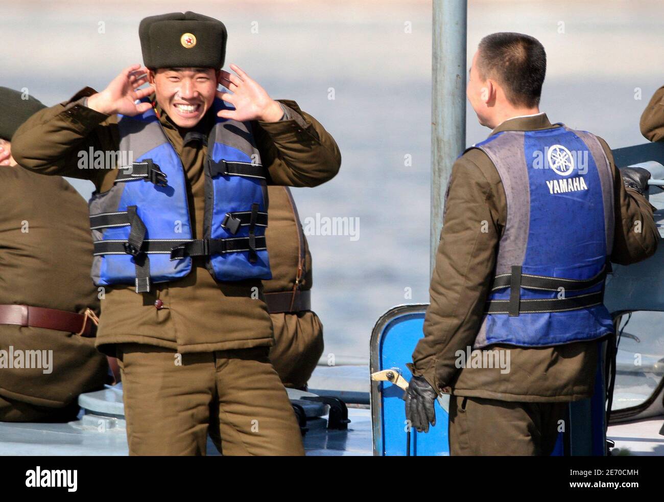 A North Korean soldier reacts while patrolling on a military boat on the Yalu River near the North Korean town of Sinuiju, opposite the Chinese border city of Dandong, March 27, 2010. South Korea's president ordered an investigation on Saturday into the cause of the sinking of a navy ship near the disputed North Korea border but officials said it was unlikely to have been the result of an attack by Pyongyang. REUTERS/Jacky Chen (NORTH KOREA - Tags: POLITICS MILITARY) Stock Photo